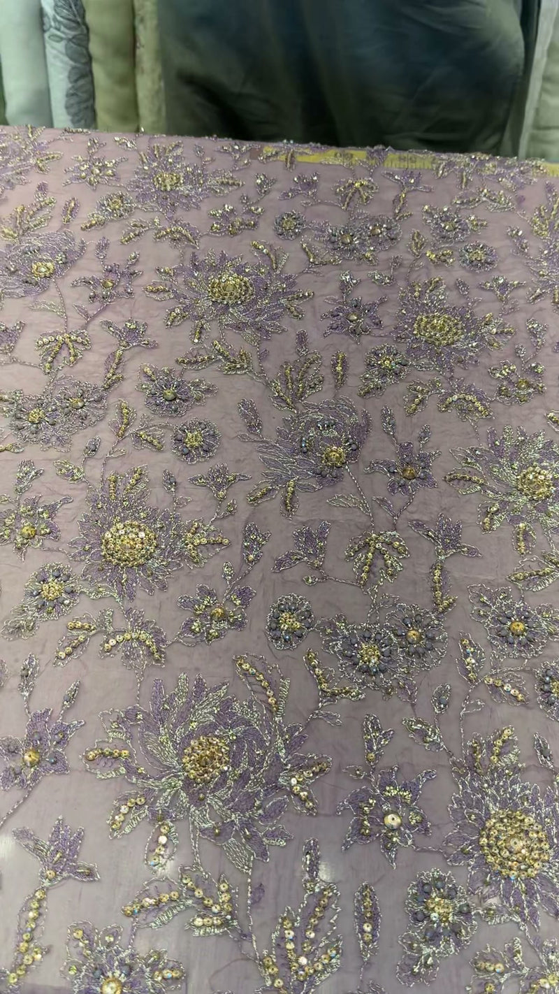 Detail of gold-tone and silver floral handwork on lilac formal