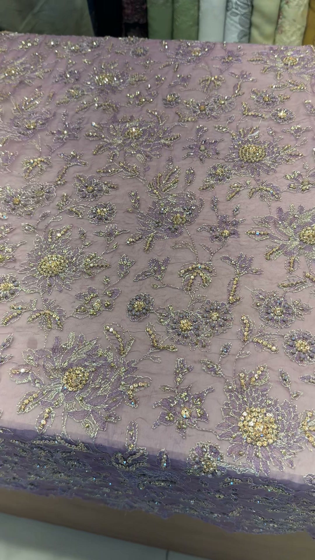 Close-up of hand-done bead and sequin embellishment on lilac chiffon