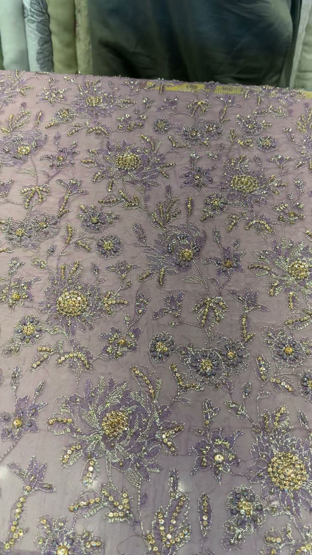 Detail of gold-tone and silver floral handwork on lilac formal