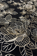 Black embroidered lawn fabric close-up